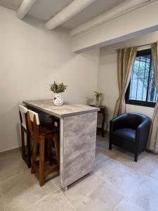 a living room with a table and chairs and a window at Chacras House in Ciudad Lujan de Cuyo