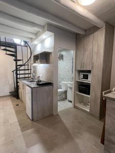 a kitchen with a sink and a stove at Chacras House in Ciudad Lujan de Cuyo