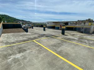 a parking lot with yellow lines on top of a building at Elite Palace Hotel in Pará de Minas