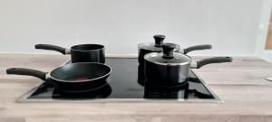 a stove with pots and pans on top of it at Shanti in Darlington