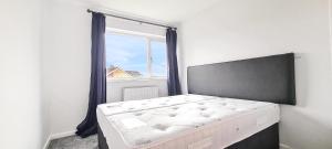 a bedroom with a bed in front of a window at Shanti in Darlington