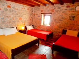 a bedroom with two beds and a window at Pirgoi Edem in Pyrgos Dirou
