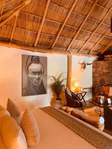a living room with a couch and a picture of a man at Casa Miura Hotel Boutique in Ajijic