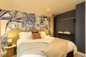 1 dormitorio con 1 cama con una pintura en la pared en Flamingo Retreat, en Leicester