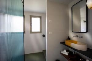 a bathroom with a shower and a sink and a mirror at H&ocirc;tel du Parc Cavalaire sur Mer in Cavalaire-sur-Mer