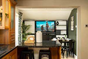 a living room with a tv on a wall at Flamingo Retreat in Leicester