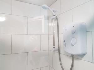 a shower in a white tiled bathroom at Charming 3-Bed Apartment in Scarning Near Dereham in East Dereham