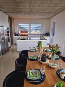 una cocina con una mesa con platos y copas de vino en Exklusives Design-Penthouse MC1 en Seligenstadt