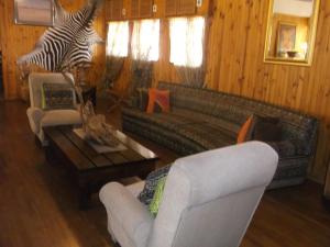 a living room with a couch and a table at Keimoes Hotel in Keimoes