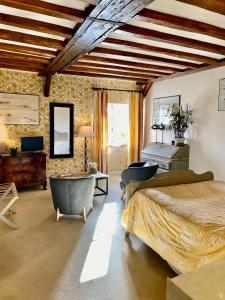 a bedroom with a bed and a desk and a piano at Domaine Des Bidaudieres in Vouvray