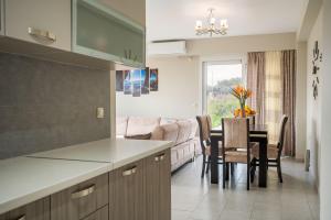 a kitchen and living room with a table and a couch at Marilena in Skala
