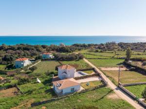 an aerial view of a house with the ocean in the background at Marilena in Skala