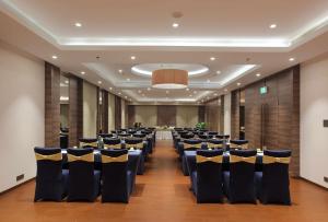 a banquet hall with chairs and tables in a room at Distrikt 9 in Palakkad