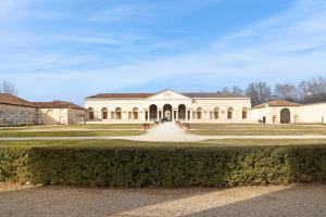 a large white building with a large driveway at La Villa in Mantova