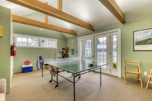 a ping pong table in a room with green walls at Seaside Classic Cottage in Seaside