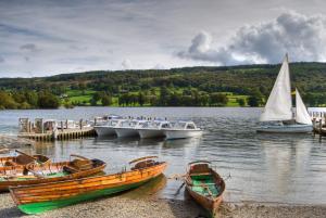 a group of boats on a body of water at Swallows Cottage Coniston in Coniston