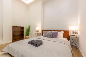 a bedroom with a large bed with two pillows on it at Exclusive Csengery Residence in the heart of Budapest in Budapest