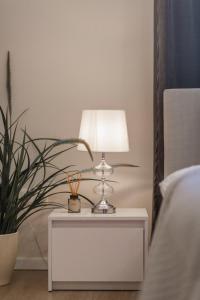 a table with a lamp on it next to a bed at Exclusive Csengery Residence in the heart of Budapest in Budapest