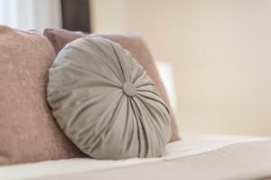 a pillow sitting on top of a bed at Exclusive Csengery Residence in the heart of Budapest in Budapest