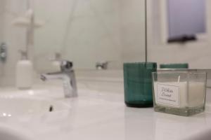 a candle sitting on a counter in a bathroom at Exclusive Csengery Residence in the heart of Budapest in Budapest