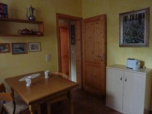 Habitación con mesa, puerta y cocina. en Ferienwohnung Haus am Singberg, en Ramsthal