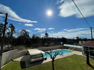 a swimming pool in the backyard of a house at Ucha Villa in Barcelos