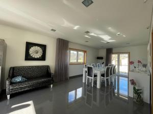 a living room with a table and a couch at Ucha Villa in Barcelos