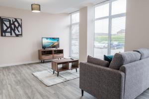 a living room with a couch and a table at Fantastic 1 Bed Apartment Manchester - Sleeps 2 in Manchester