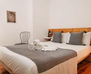 a bedroom with a large bed with towels on it at 262 Baixa Guesthouse in Lisbon