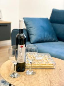 a bottle of wine and two wine glasses on a table at Tijana 2 in Pale +15 photos
