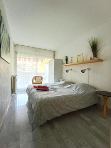 a bedroom with a bed and a chair in a room at Tribuperez à Juan-Antibes in Juan-les-Pins