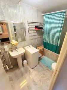 a bathroom with a toilet and a sink and a shower at Tribuperez à Juan-Antibes in Juan-les-Pins