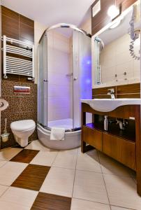 a bathroom with a sink and a shower at Ośrodek Rekreacyjny Aga in Gąski +65 photos