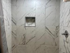 a shower with a glass door in a bathroom at Mystic Sea in Myrtle Beach