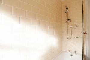 a bathroom with a shower and a bath tub at Number 8 The Townhouse in Derry Londonderry