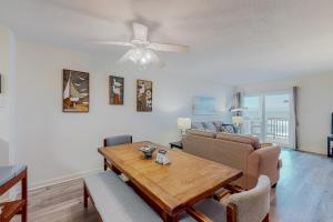 a living room with a table and a couch at Docktor's Oarders 180 RR in Rodanthe