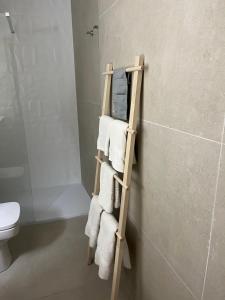 a towel rack in a bathroom with a toilet at Pensió Torrent in L'Escala