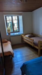 a bedroom with two beds and a window at Escale du château de Promery 1389 in Annecy