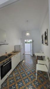 a kitchen with a stove and a table and a counter top at Alegria in Posidhonía