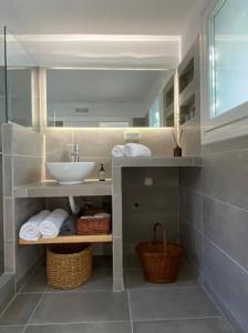 a bathroom with a sink and a mirror at Alegria in Posidhonía