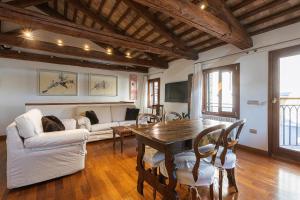 a living room with a table and chairs and a couch at San Marco Luxury Loft with Terrace in Venice