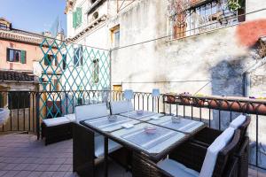 a table and chairs sitting on a balcony at San Marco Luxury Loft with Terrace in Venice