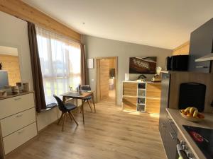 a kitchen with a table and a dining room at Römer Appartement mit sonniger Terrasse in Bad Reichenhall