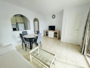 a bedroom with a table and chairs and a bed at A531 - Calasol - 2004 Finestrat s.l. in Cala de Finestrat