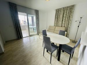 a living room with a white table and chairs at A531 - Calasol - 2004 Finestrat s.l. in Cala de Finestrat +21 photos