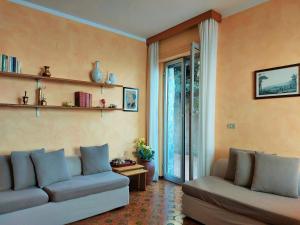 Una sala de estar con dos sofás y una ventana. en La Rosa dei Venti, en Bergeggi