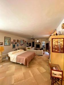 a large bedroom with two beds and a fireplace at Palazzo Sabella Tommasi in Calimera