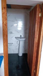 a bathroom with a white sink in a room at Finca El Encanto del Guejar in Lejanías