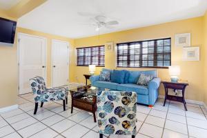 a living room with a blue couch and a chair at Southernmost Retreat in Key West