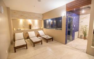 a living room with two chairs and a table at Flat Hotel Vision Hplus frente para Esplanada - SEM CAFÉ - Acomodação Particular in Brasilia